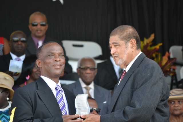 David Joseph receiving his award for his sterling contribution in the area of Community Service from Deputy Governor General His Honour Eustace John at the 32nd Anniversary Independence Ceremonial Parade and Awards Ceremony at the Elquemedo T. Willet Park on September 19, 2015